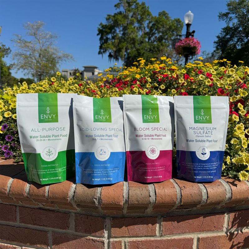 Image of ENVY Plant Foods products in front of flowers