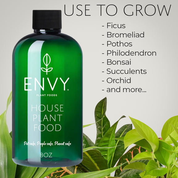 Bottle of Envy house plant food with text listing plants it can grow on a gray background
